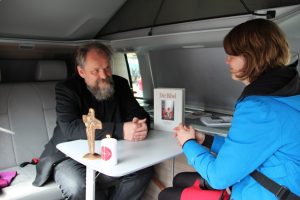 Pater Hermann-Josef Hubka im Gespräch mit einer Besucherin des Beichtmobils. (Foto: KIRCHE IN NOT)