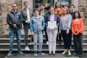 Vertreterinnen und Vertreter aus Politik, vom Amt für Gleichstellung und vom Amt für Immobilienmanagement sowie Schulleiterin Sabine Langenberg (Mitte) und SV-Vertreterin Halaz Mohammad (r.) (Foto: Stadt Münster/Meike Reiners)